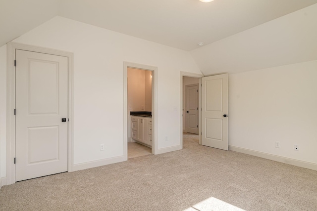 1709 Martha Washington Way, Murfreesboro, TN 37130 - unfurnished bedroom with vaulted ceiling, light carpet, baseboards, and ensuite bath