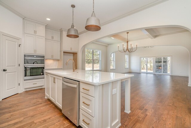 1709 Martha Washington Way, Murfreesboro, TN 37130 - kitchen featuring a sink, arched walkways, stainless steel appliances, open floor plan, and a chandelier