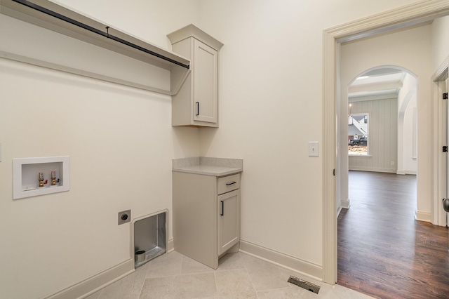 1709 Martha Washington Way, Murfreesboro, TN 37130 - clothes washing area featuring hookup for a washing machine, hookup for an electric dryer, arched walkways, baseboards, and cabinet space