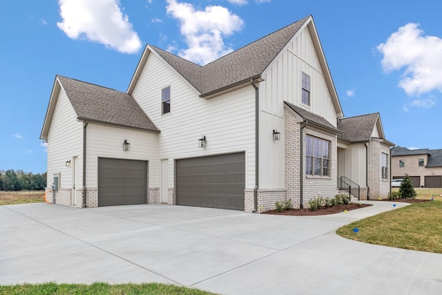 1900 Martha Washington Way, Murfreesboro, TN 37130 - view of side of property featuring brick siding, concrete driveway, a garage, board and batten siding, and roof with shingles