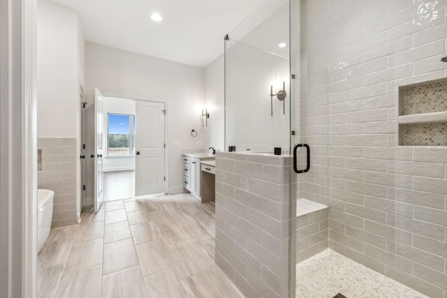 1900 Martha Washington Way, Murfreesboro, TN 37130 - full bath featuring a stall shower, a soaking tub, vanity, recessed lighting, and tile walls
