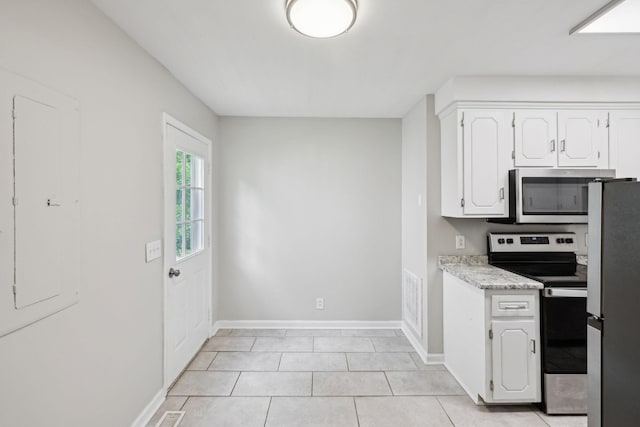 932 Circle Dr, Springfield, TN 37172 - kitchen with stainless steel appliances, light countertops, white cabinets, baseboards, and light tile patterned flooring
