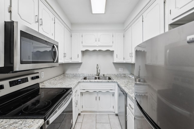 932 Circle Dr, Springfield, TN 37172 - kitchen featuring stainless steel appliances, a sink, white cabinetry, and light tile patterned flooring