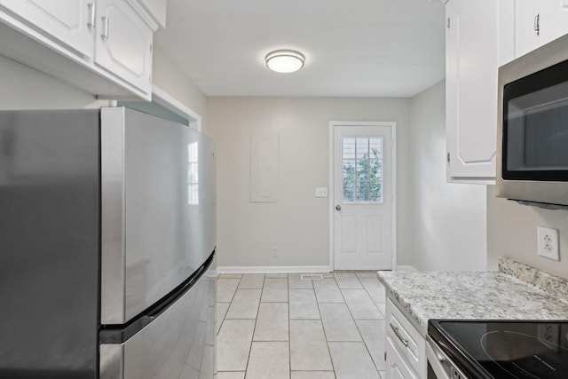932 Circle Dr, Springfield, TN 37172 - kitchen with appliances with stainless steel finishes, white cabinets, light tile patterned floors, baseboards, and light stone counters