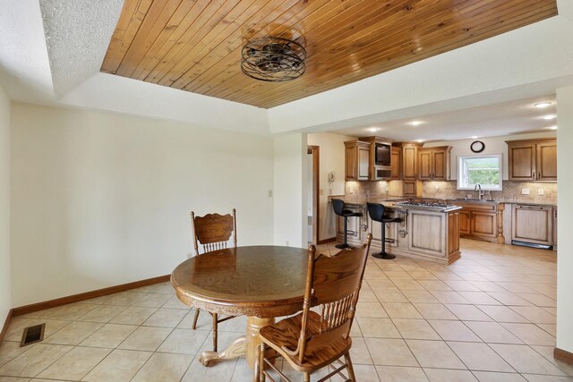 1361 Madison Creek Rd, Goodlettsville, TN 37072 - dining space featuring light tile patterned floors, wood ceiling, recessed lighting, and a tray ceiling