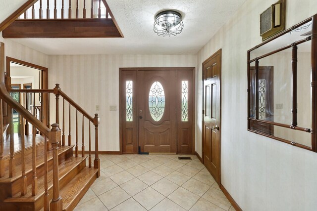 1361 Madison Creek Rd, Goodlettsville, TN 37072 - entryway featuring wallpapered walls, light tile patterned floors, stairs, and a textured ceiling