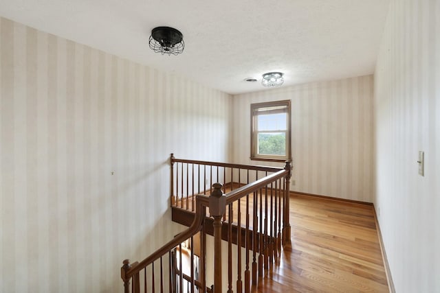1361 Madison Creek Rd, Goodlettsville, TN 37072 - staircase featuring wallpapered walls, wood finished floors, and a textured ceiling