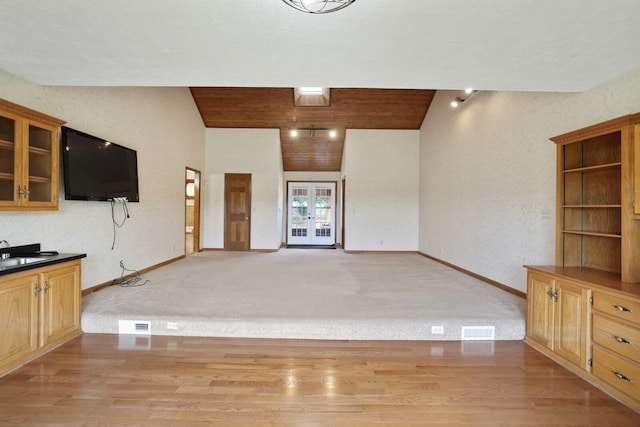 1361 Madison Creek Rd, Goodlettsville, TN 37072 - unfurnished living room featuring lofted ceiling, french doors, light wood-style floors, and light carpet
