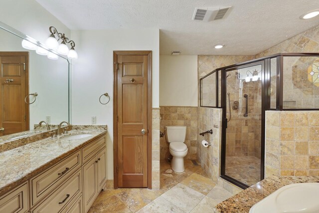 1361 Madison Creek Rd, Goodlettsville, TN 37072 - bathroom with a stall shower, vanity, a textured ceiling, tile walls, and a tub to relax in