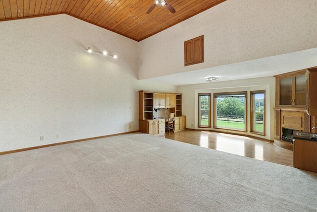 1361 Madison Creek Rd, Goodlettsville, TN 37072 - unfurnished living room with a fireplace with raised hearth, ceiling fan, carpet floors, wooden ceiling, and high vaulted ceiling
