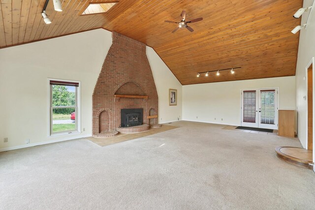 1361 Madison Creek Rd, Goodlettsville, TN 37072 - unfurnished living room featuring rail lighting, wood ceiling, carpet floors, a fireplace, and a ceiling fan