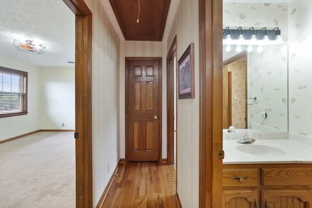 1361 Madison Creek Rd, Goodlettsville, TN 37072 - hall featuring attic access, wallpapered walls, a textured ceiling, and light wood-style floors