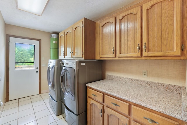 1361 Madison Creek Rd, Goodlettsville, TN 37072 - laundry room with washer and clothes dryer, cabinet space, and light tile patterned floors