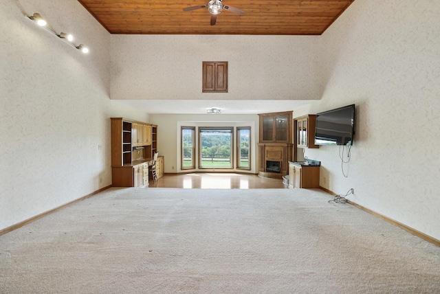 1361 Madison Creek Rd, Goodlettsville, TN 37072 - unfurnished living room with a fireplace with raised hearth, wooden ceiling, light carpet, ceiling fan, and a textured wall