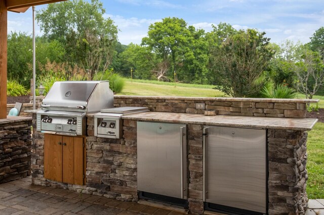 1361 Madison Creek Rd, Goodlettsville, TN 37072 - view of patio with exterior kitchen and view of scattered trees