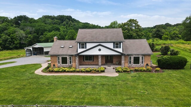 1361 Madison Creek Rd, Goodlettsville, TN 37072 - view of front of house with a porch, a front yard, a chimney, and a forest view