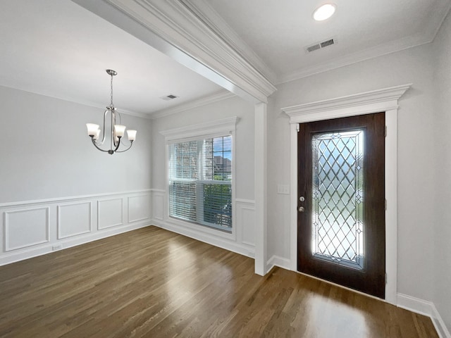 1117 Bandini Ct, Lascassas, TN 37085 - entrance foyer featuring a chandelier, dark wood finished floors, a wainscoted wall, and ornamental molding