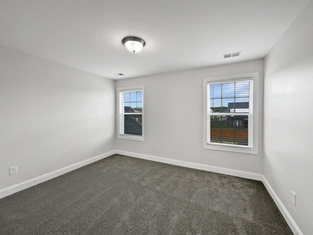 1117 Bandini Ct, Lascassas, TN 37085 - empty room featuring plenty of natural light, dark colored carpet, and baseboards