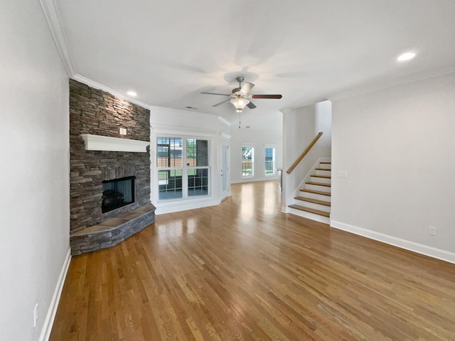 1117 Bandini Ct, Lascassas, TN 37085 - unfurnished living room with stairs, ceiling fan, crown molding, baseboards, and a stone fireplace