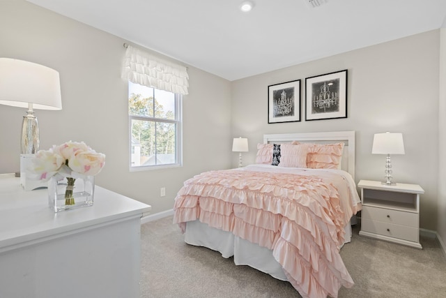 bedroom featuring light colored carpet and baseboards