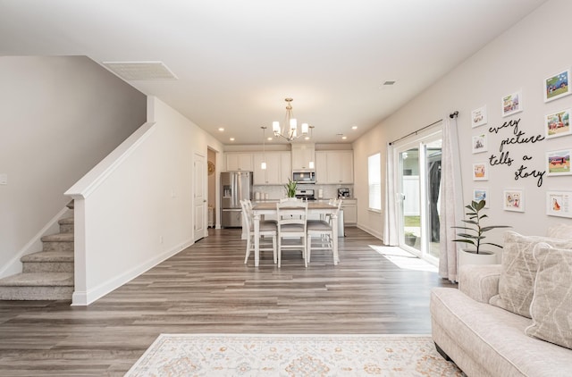 1063 Holland Ridge Way, Lebanon, TN 37090 - living room with stairway, a chandelier, light wood-style floors, recessed lighting, and baseboards