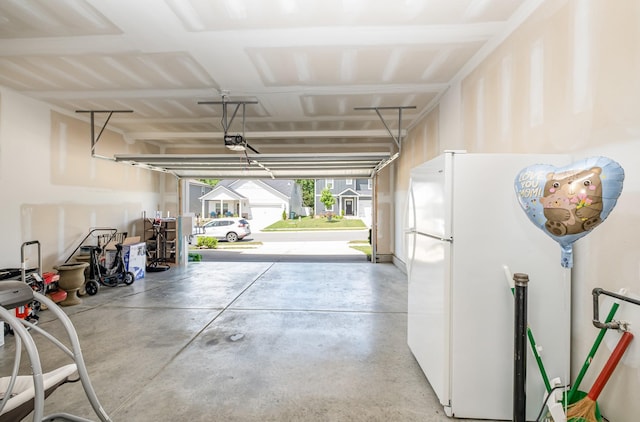 1063 Holland Ridge Way, Lebanon, TN 37090 - garage featuring freestanding refrigerator and a garage door opener