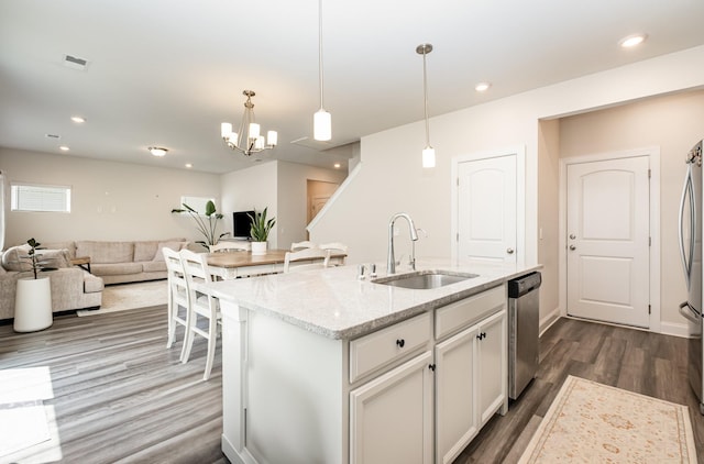 1063 Holland Ridge Way, Lebanon, TN 37090 - kitchen with a sink, stainless steel appliances, dark wood-style flooring, light stone counters, and a chandelier