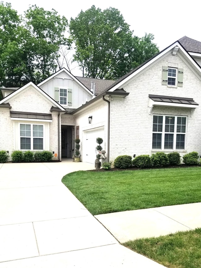 501 Wright Branch Cv, Hermitage, TN 37076 - view of front of property with brick siding, board and batten siding, a front lawn, an attached garage, and concrete driveway