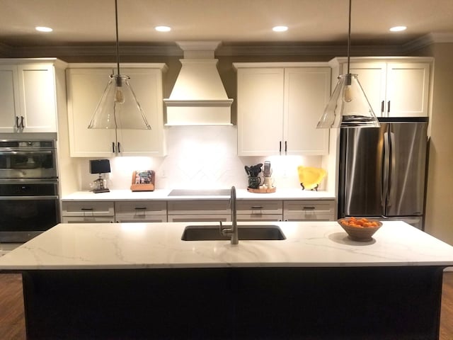 501 Wright Branch Cv, Hermitage, TN 37076 - kitchen with appliances with stainless steel finishes, a sink, custom range hood, crown molding, and white cabinetry