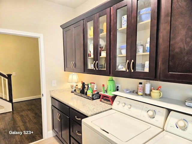 501 Wright Branch Cv, Hermitage, TN 37076 - kitchen with washing machine and clothes dryer, light countertops, wood finished floors, glass insert cabinets, and baseboards
