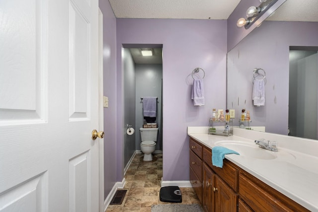 104 Pierce Pl, Unionville, TN 37180 - bathroom with toilet, baseboards, vanity, stone finish flooring, and a textured ceiling