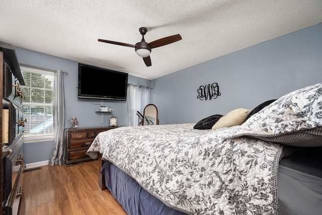 104 Pierce Pl, Unionville, TN 37180 - bedroom with light wood finished floors, a textured ceiling, a ceiling fan, and baseboards