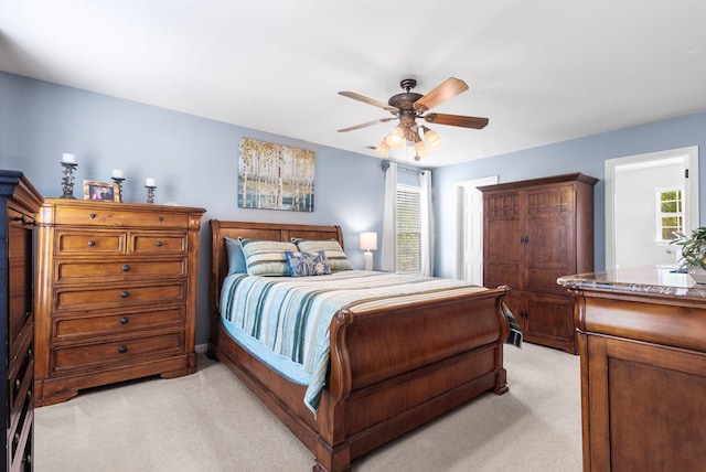 bedroom with light carpet and ceiling fan