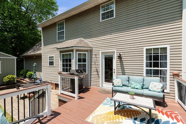 deck with an outdoor living space and a grill