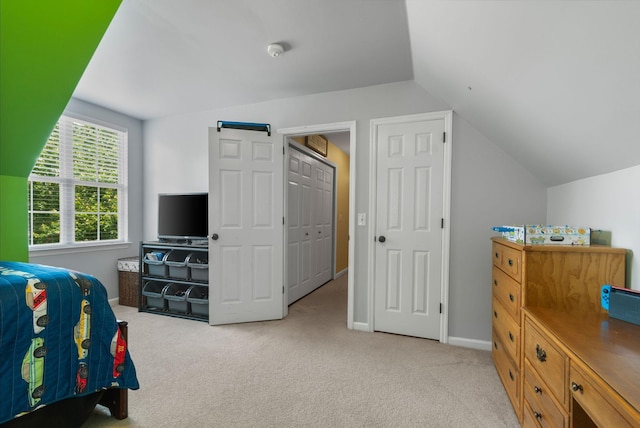 bedroom featuring carpet and lofted ceiling
