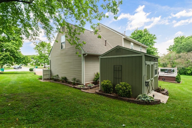rear view of property with a storage unit, an outbuilding, and a yard