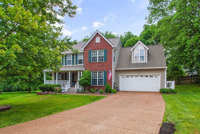 colonial-style house featuring covered porch, a garage, driveway, roof with shingles, and brick siding