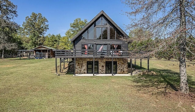 back of property with log siding, a deck, a yard, and a patio