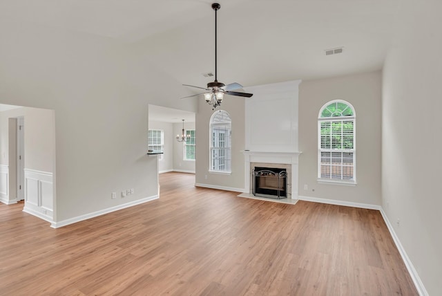 4725 Cape Hope Pass, Hermitage, TN 37076 - unfurnished living room featuring a chandelier, a fireplace with flush hearth, light wood-style flooring, a ceiling fan, and lofted ceiling