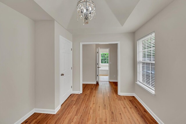4725 Cape Hope Pass, Hermitage, TN 37076 - hallway with a chandelier, light wood-type flooring, and baseboards