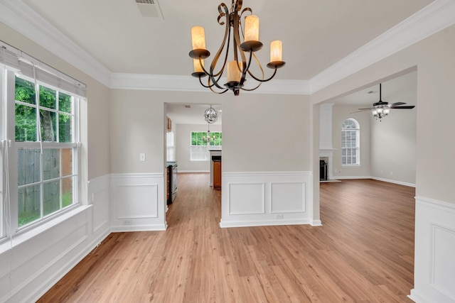 4725 Cape Hope Pass, Hermitage, TN 37076 - unfurnished dining area with a chandelier, a wainscoted wall, healthy amount of natural light, light wood-type flooring, and ornamental molding