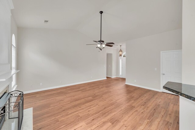 4725 Cape Hope Pass, Hermitage, TN 37076 - unfurnished living room with a ceiling fan, a fireplace with flush hearth, light wood finished floors, a chandelier, and lofted ceiling
