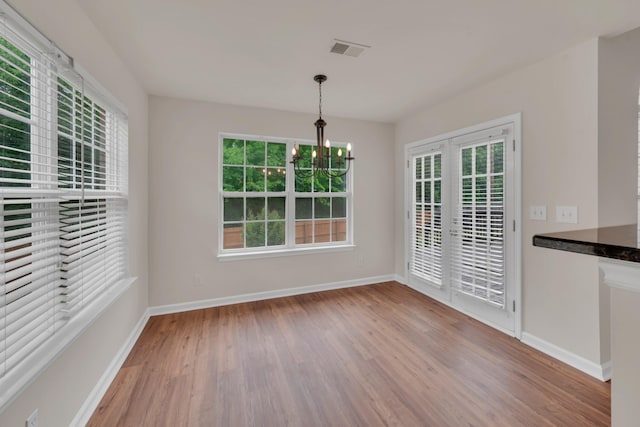 4725 Cape Hope Pass, Hermitage, TN 37076 - unfurnished dining area featuring a chandelier, wood finished floors, baseboards, and plenty of natural light