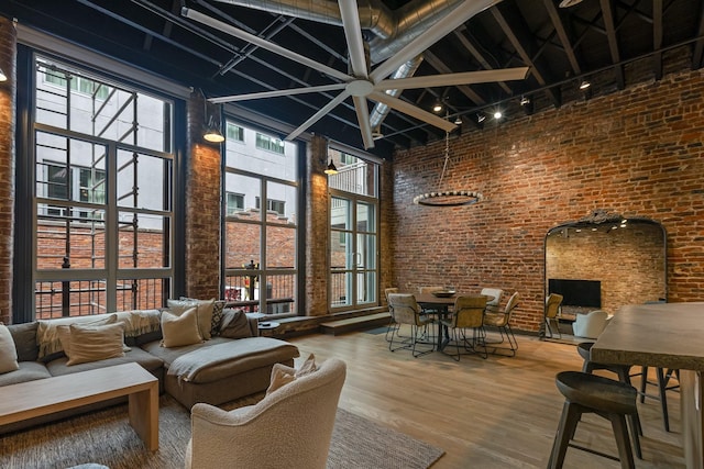interior space featuring healthy amount of natural light, rail lighting, and beamed ceiling