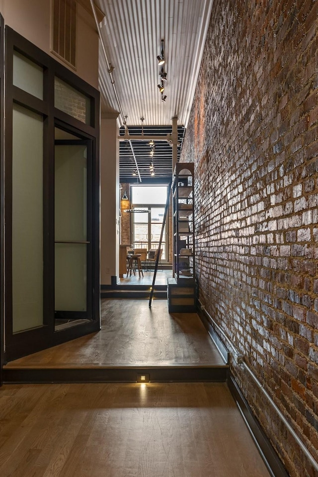 hallway with brick wall