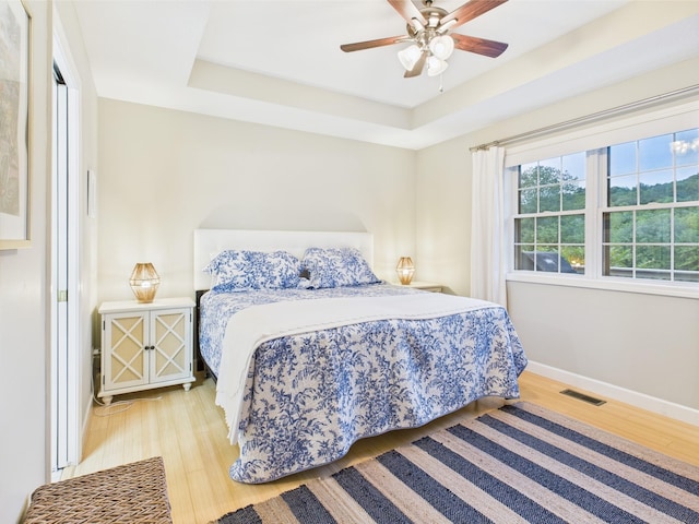 378 Roy Harris Rd, Kuttawa, KY 42055 - bedroom with wood finished floors, baseboards, a raised ceiling, and ceiling fan
