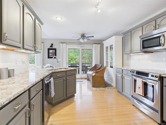 378 Roy Harris Rd, Kuttawa, KY 42055 - kitchen featuring stainless steel appliances, a sink, gray cabinets, ceiling fan, and decorative backsplash