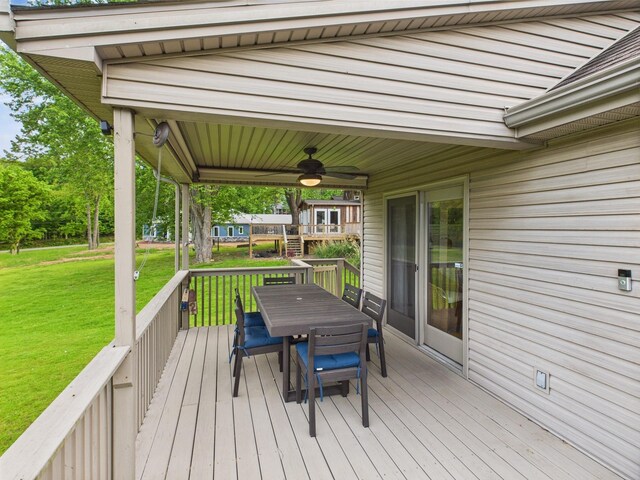 378 Roy Harris Rd, Kuttawa, KY 42055 - wooden terrace featuring ceiling fan, outdoor dining area, and a lawn