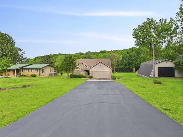 378 Roy Harris Rd, Kuttawa, KY 42055 - single story home featuring a garage, a front lawn, and an outbuilding