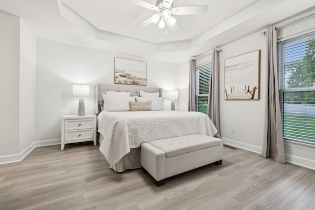 9455 Foothills Ct, Brentwood, TN 37027 - bedroom with a raised ceiling, light wood-style floors, and ceiling fan